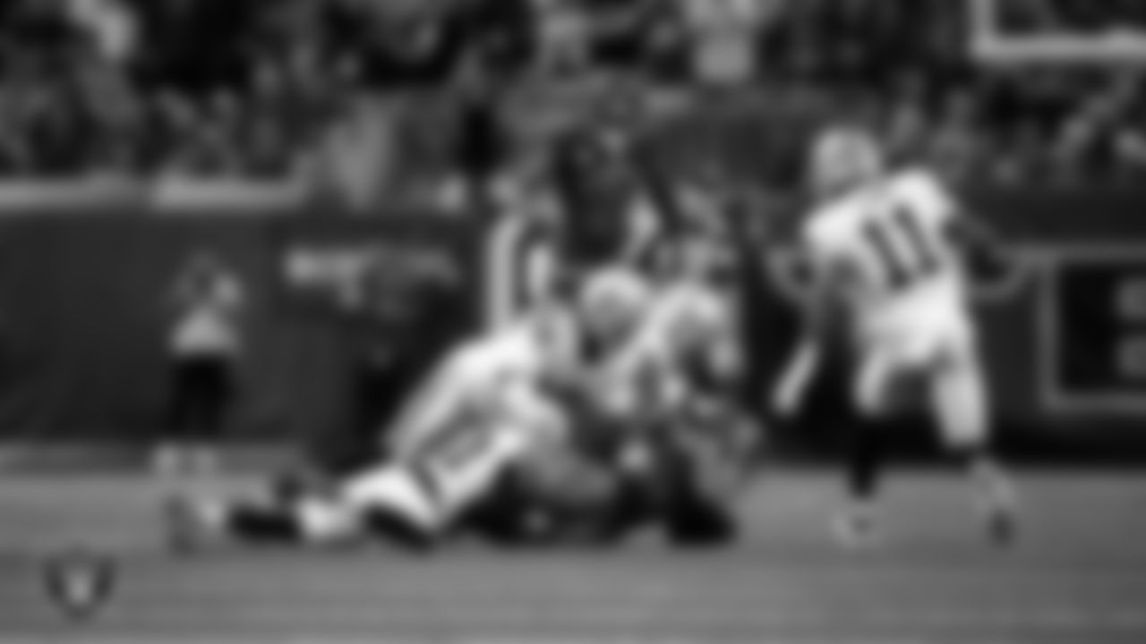 Las Vegas Raiders cornerback Eric Stokes (22), safety Lonnie Johnson Jr. (32) and safety Isaiah Pola-Mao (20) make a tackle during the regular season away game against the Houston Texans at NRG Stadium.