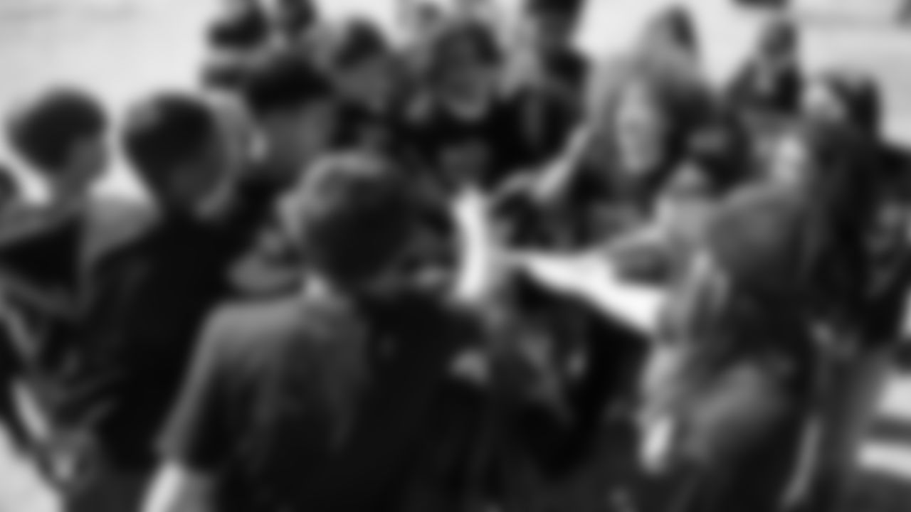 Students huddle during a Raiders Junior Training Camp at Steve Schorr Elementary School.