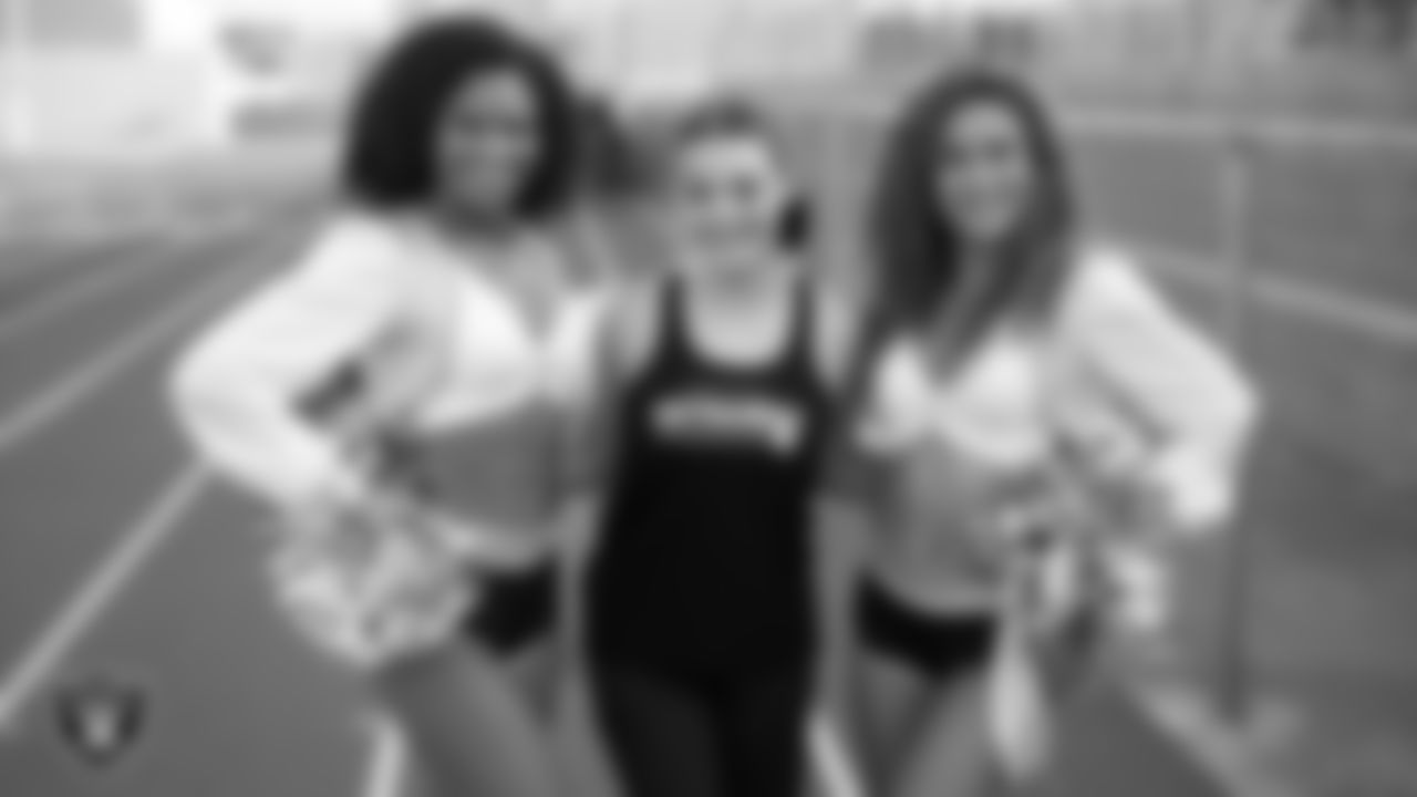 Raiderettes Shayla and Jenna W. pose for a photo with a member of the Silverado High School spirit dance team before the Las Vegas Raiders' Football Showcase game between Silverado and Foothill High School at Silverado High School.