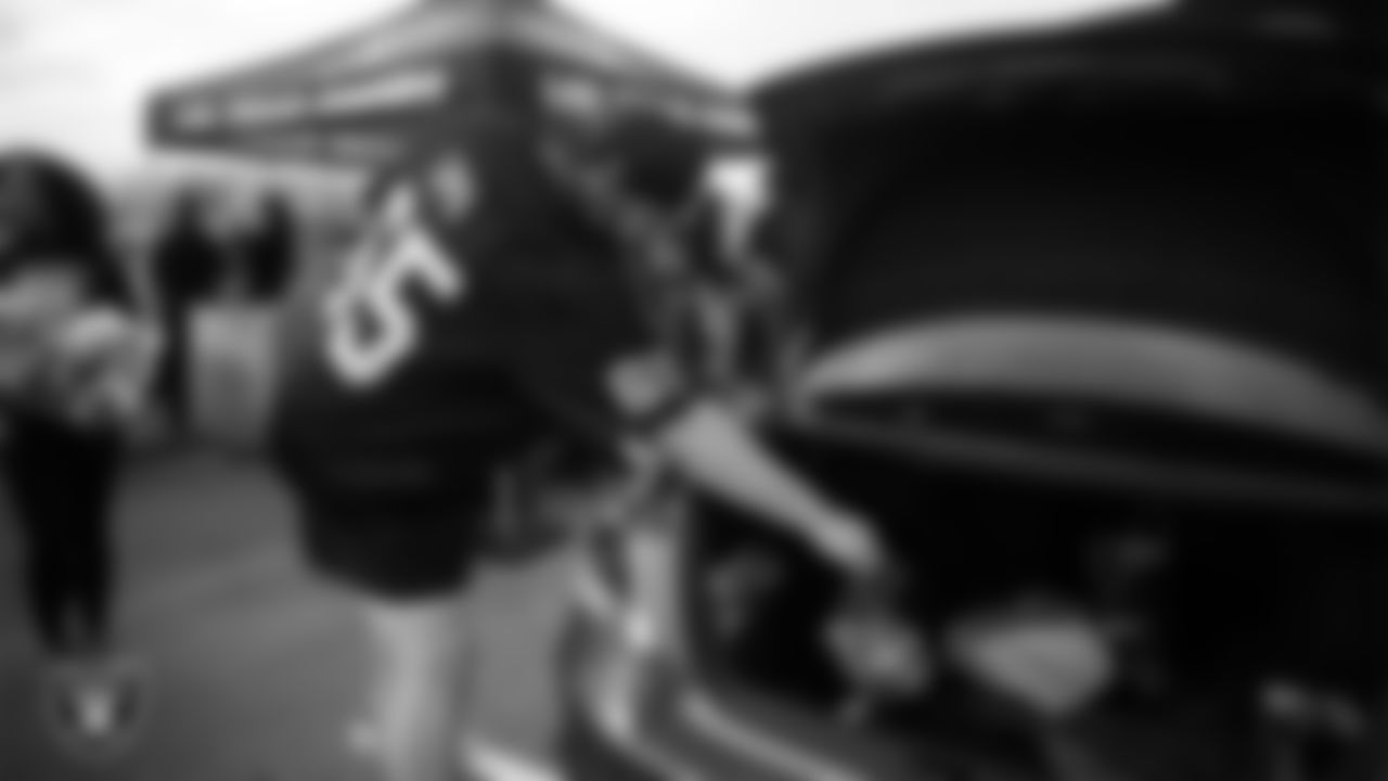 Las Vegas Raiders guard Alex Cappa (65) helps distribute Thanksgiving meals to families during Turkey Time with the O-Line at Allegiant Stadium.