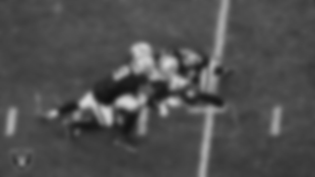 Las Vegas Raiders defensive end Tyree Wilson (9) and safety Lonnie Johnson Jr. (32) make a tackle during the regular season home game against the New York Giants at Allegiant Stadium.