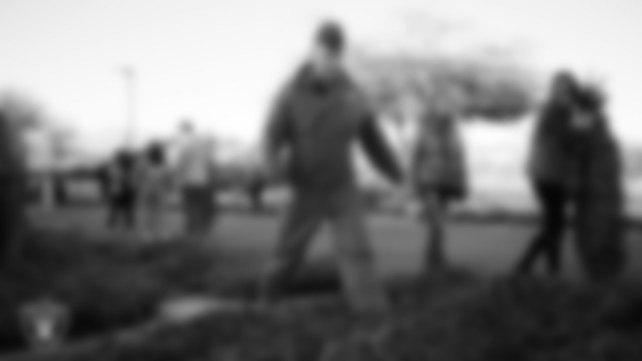 Air Force members and their families pick out a tree during the Raiders Holiday Salute at Nellis Air Force Base - Coral Academy.