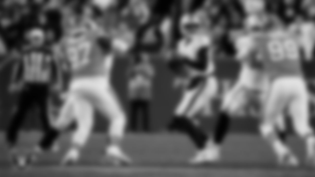 Las Vegas Raiders quarterback Geno Smith (7) looks for a receiver during the regular season away game against the Denver Broncos at Empower Field at Mile High.