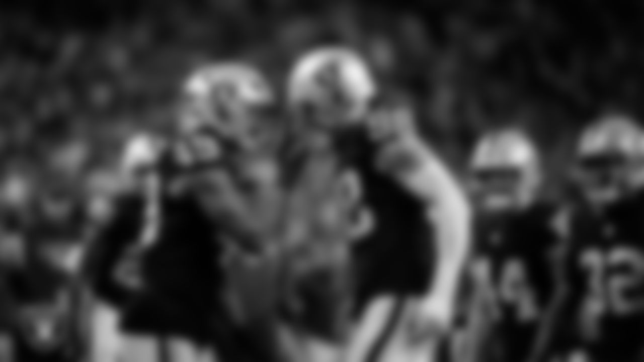 Las Vegas Raiders defensive end Maxx Crosby (98) celebrates with defensive end Charles Snowden (49) after forcing a fumble during the regular season home game against the Dallas Cowboys at Allegiant Stadium.