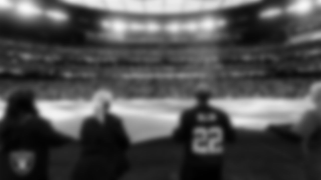 The American flag is displayed by Personal Seat License (PSL) holders on the field during the national anthem before the Las Vegas Raiders' regular season home game against the Cleveland Browns at Allegiant Stadium.