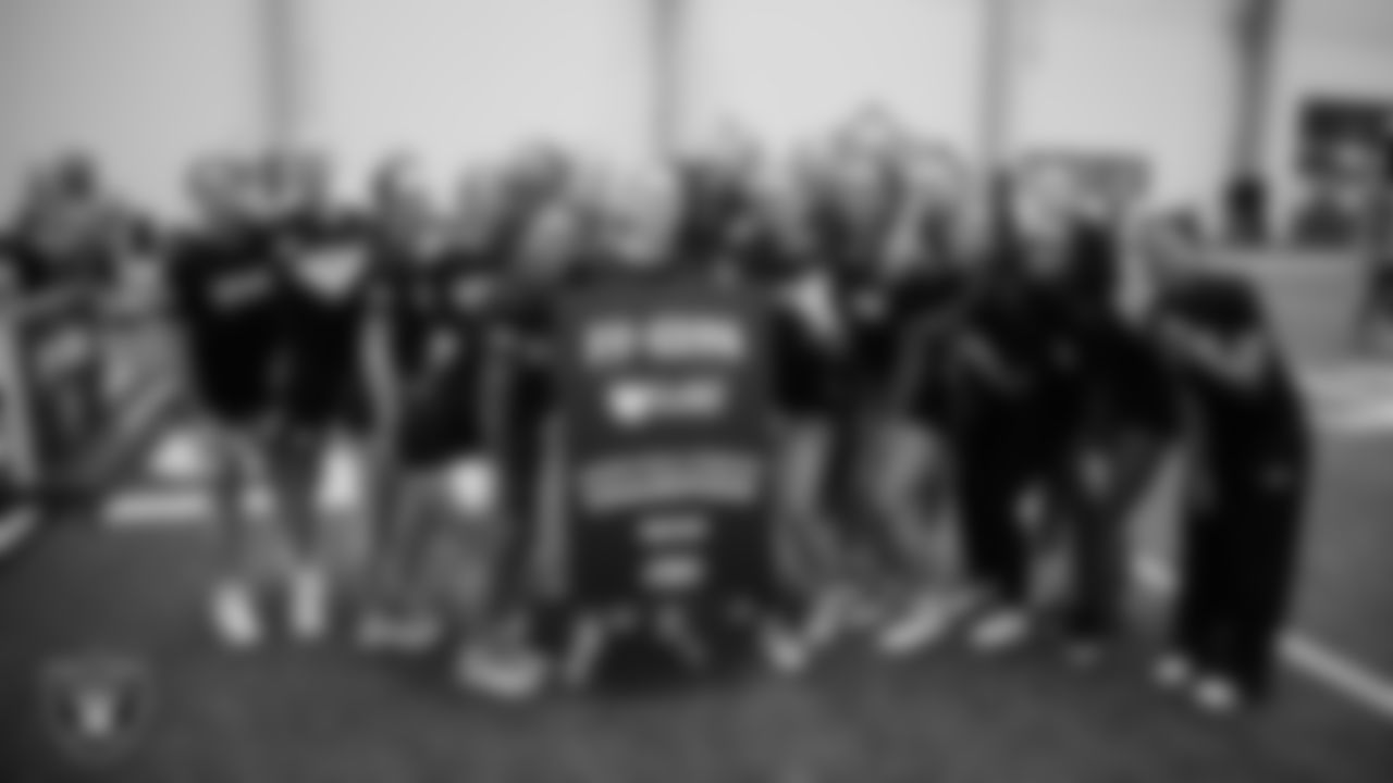 The winner of the Long Ball Throw competition poses for a photo with teammates during a Nike 11-On event at Intermountain Health Performance Center.