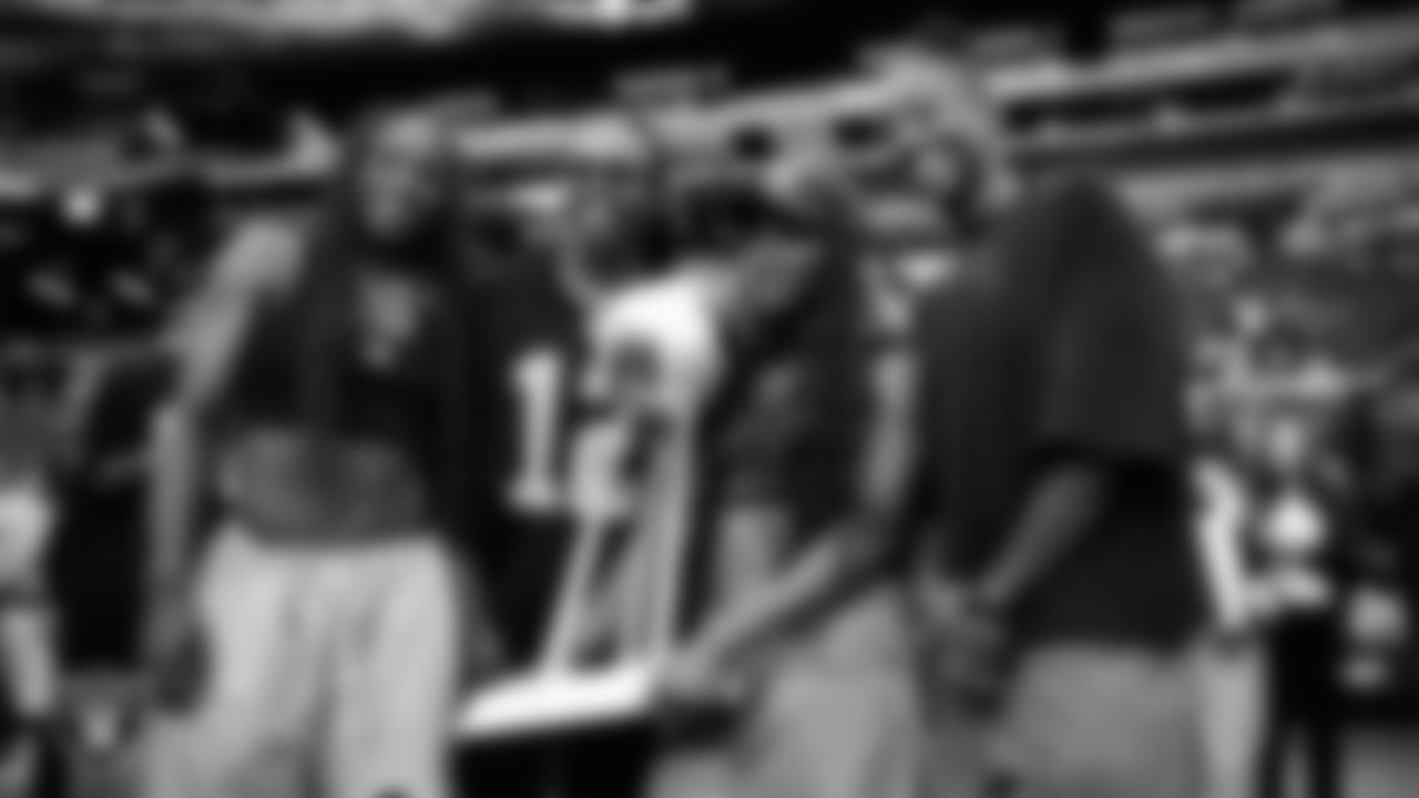 Las Vegas Aces guard Jackie Young, guard Chelsea Gray, guard Dana Evans and guard Jewell Loyd pose for a photo with the Commissioner's Cup Trophy before the Las Vegas Raiders' regular season home game against the Tennessee Titans at Allegiant Stadium.