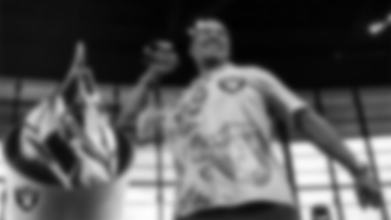 Las Vegas Raiders alumnus Jerry Robinson lights the Al Davis Memorial Torch before the Las Vegas Raiders' regular season home game against the Chicago Bears at Allegiant Stadium.