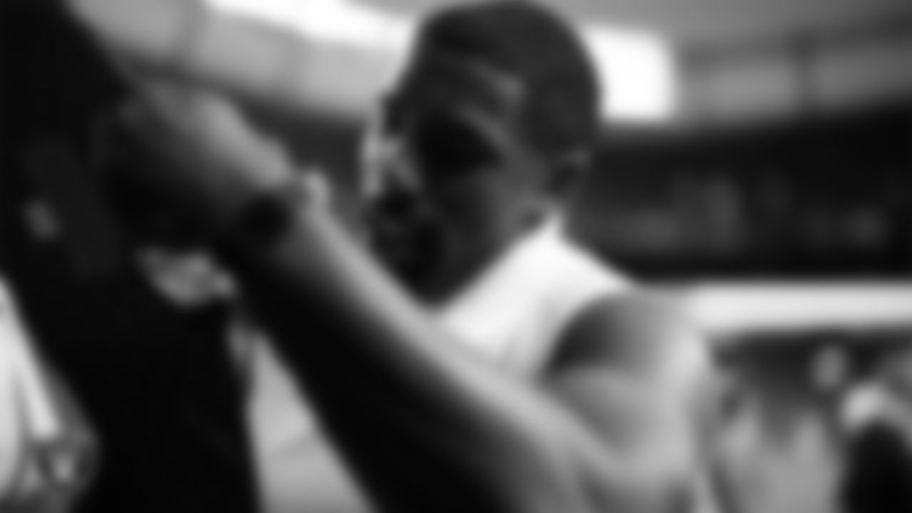 Las Vegas Raiders defensive tackle Thomas Booker IV (99) signs autographs for fans before the regular season away game against the Denver Broncos at Empower Field at Mile High.