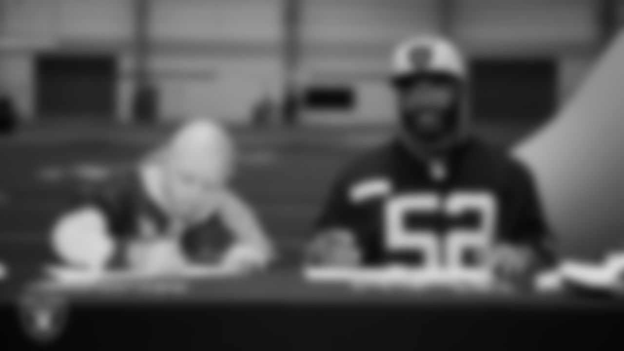 Las Vegas Raiders linebacker Elandon Roberts (52) designs cleats for My Cause My Cleats with Intermountain Children's Health patient Isaak at Intermountain Health Performance Center.