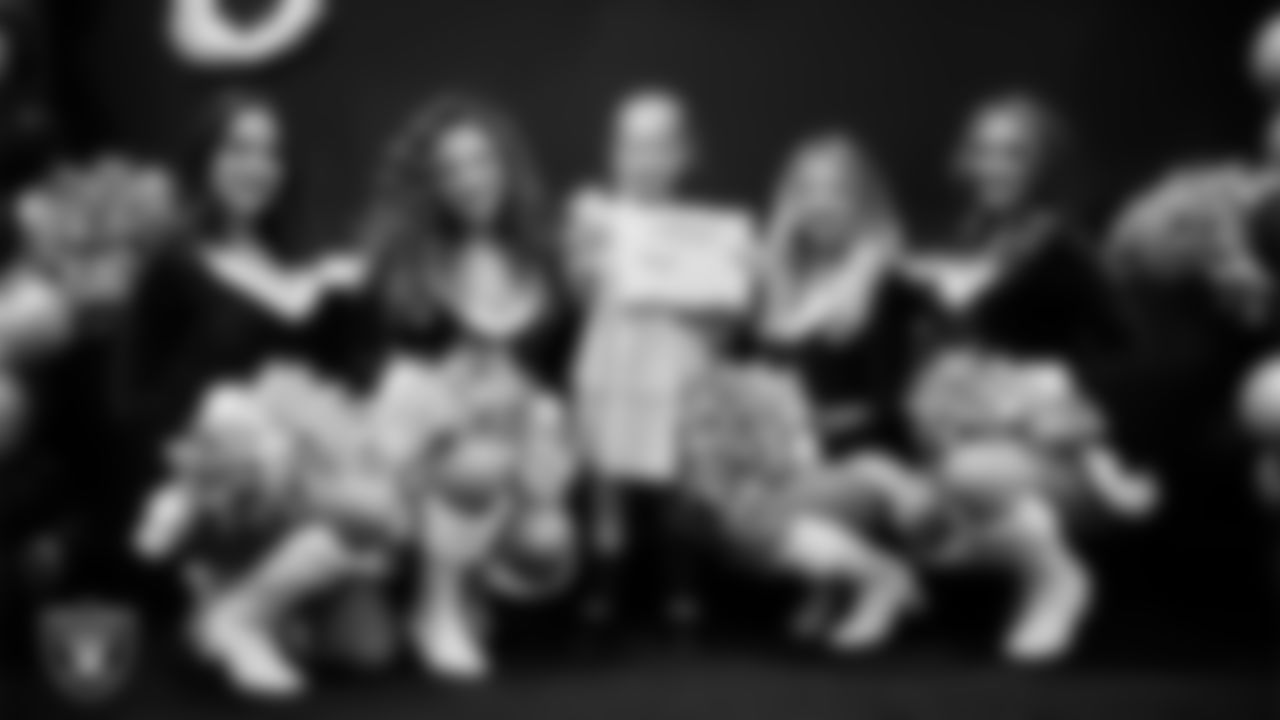 Raiderettes pose for a photo with a Junior Raiderette during the Junior Raiderettes Banquet at The Studio.