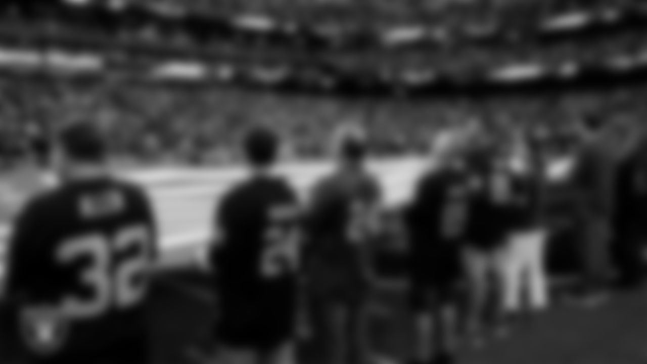 The American flag is displayed by Personal Seat License (PSL) holders on the field during the national anthem before the Las Vegas Raiders' regular season home game against the Jacksonville Jaguars at Allegiant Stadium.