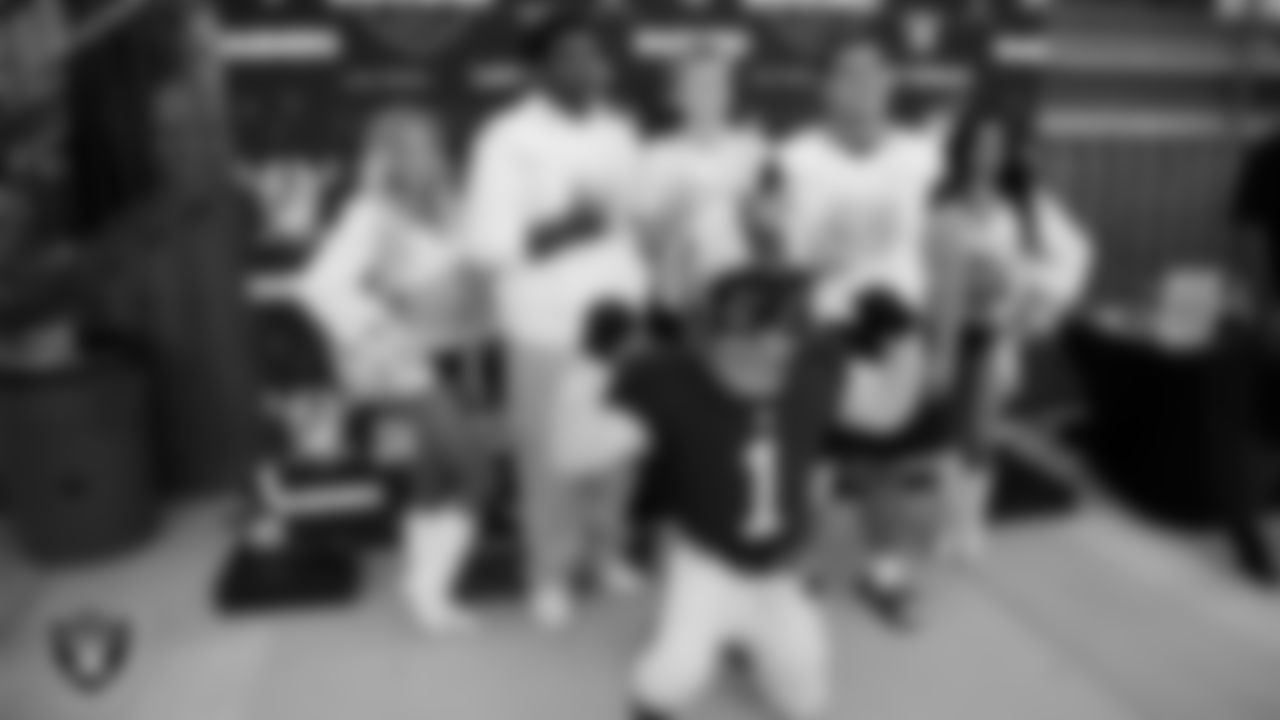 Raiderettes Jordie and Annalise and Raider Rusher pose for a photo with students before the Las Vegas Raiders' Football Showcase game at Bishop Gorman High School.