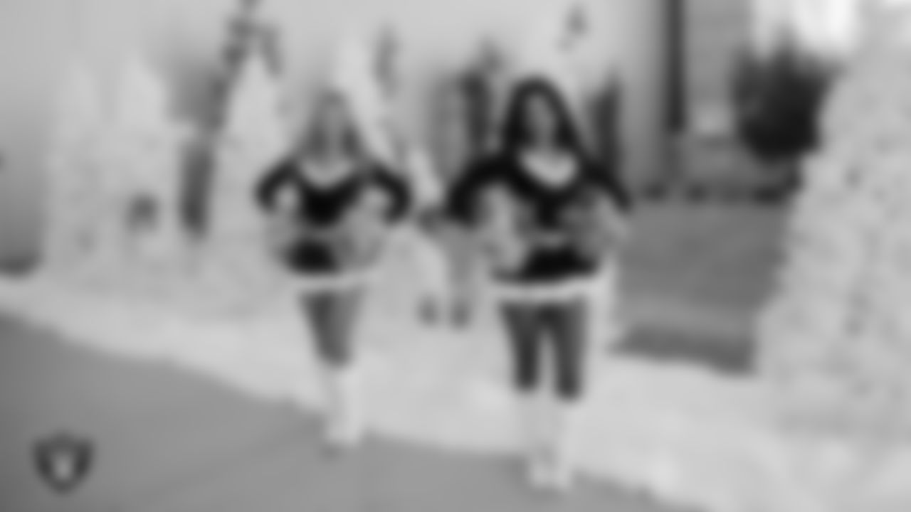 Raiderettes Ali and Annalise welcome students to a Raiders Youth Holiday Party at Intermountain Health Performance Center.