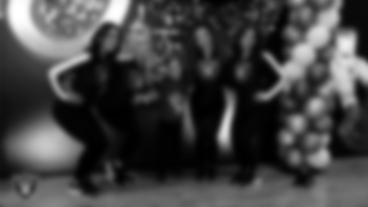 Raiderettes Reagan, Delaney, Lexie and Ashtin pose for a photo with an attendee during the Valentine's Day Dance at The Studio.