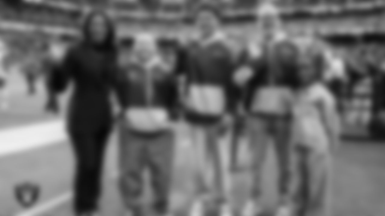 Las Vegas Raiders President Sandra Douglass Morgan and Intermountain Health Regional President Mitch Cloward pose for a photo with Intermountain Children's Health patients Isaak, Evelyn and Aiden in their custom shoes for the NFL's My Cause My Cleats initiative before the Raiders' regular season home game against the Cleveland Browns at Allegiant Stadium.