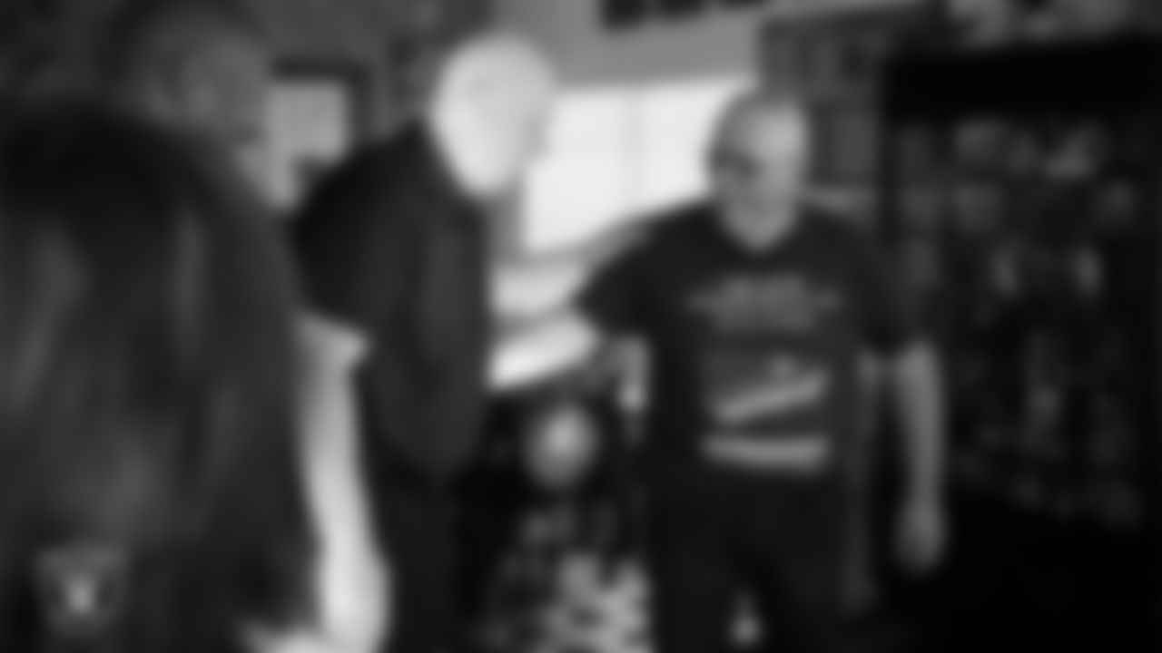United States Navy Veteran Michael Royal speaks with Las Vegas Raiders alumnus Jay Schroeder after being surprised with tickets to the Raiders' Salute to Service game.