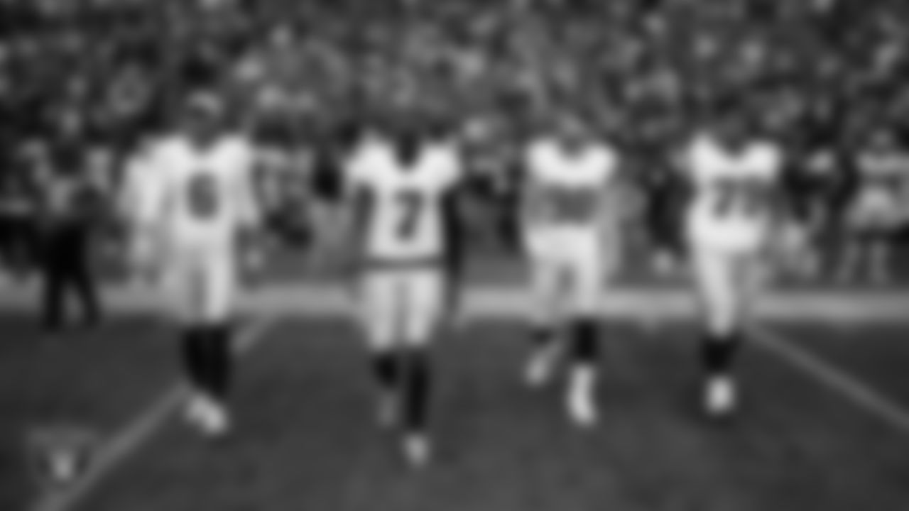 Las Vegas Raiders punter AJ Cole (6), quarterback Geno Smith (7), defensive end Maxx Crosby (98) and offensvie lineman Laki Tasi (79) walk out to the center of the field for the coin toss before the preseason away game against the the Seattle Seahawks at Lumen Field.