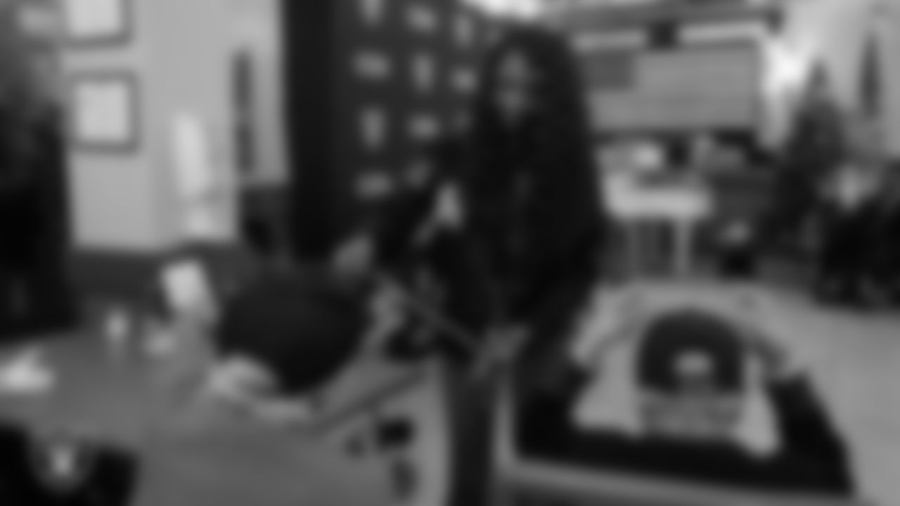 Las Vegas Raiders senior manager of corporate partnership activation Jamie Gary hands out Raiders gear to a veteran during the annual Cox Salute to Service Tailgate at Southern Nevada State Veterans Home.