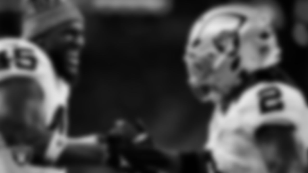 Las Vegas Raiders running back Ashton Jeanty (2) celebrates with linebacker Devin White (45) after making a 60-yard touchdown catch during the regular season away game against the Houston Texans at NRG Stadium.