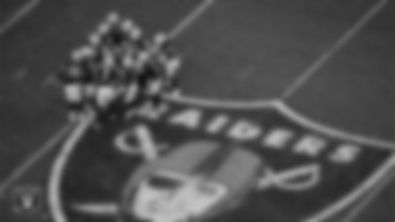 The Las Vegas Raiders offense huddles during the regular season home game against the New York Giants at Allegiant Stadium.