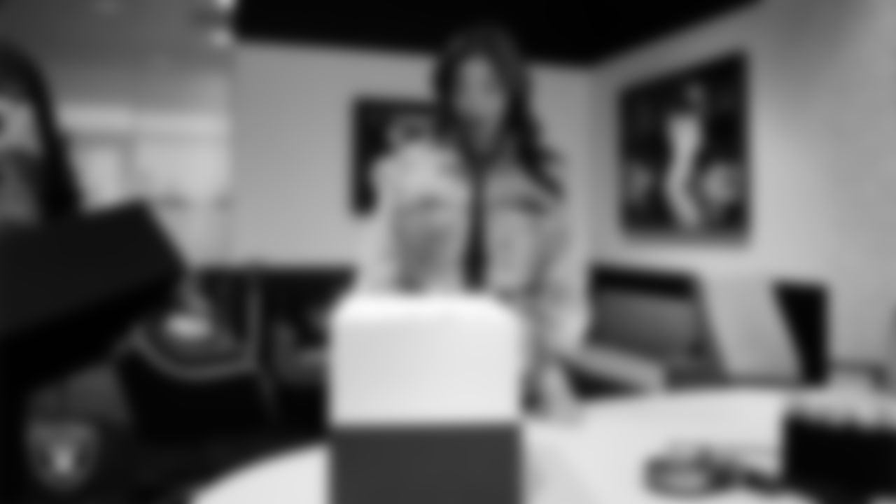 Las Vegas Raiders President Sandra Douglass Morgan unboxes her custom shoes for the NFL's My Cause My Cleats initiative at Intermountain Health Performance Center.