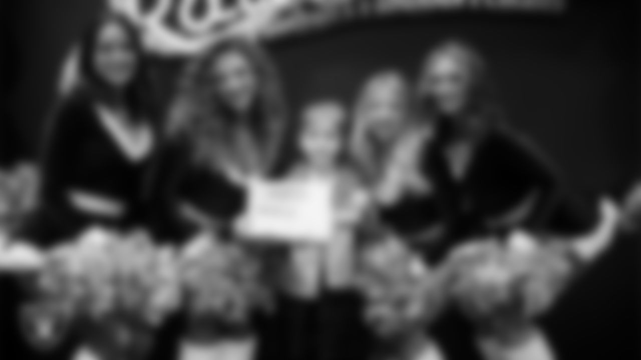 Raiderettes pose for a photo with a Junior Raiderette during the Junior Raiderettes Banquet at The Studio.