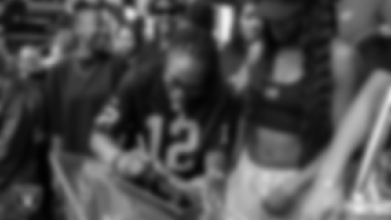 Las Vegas Aces guard Chelsea Gray signs the Al Davis Memorial torch before the Las Vegas Raiders' regular season home game against the Tennessee Titans at Allegiant Stadium.