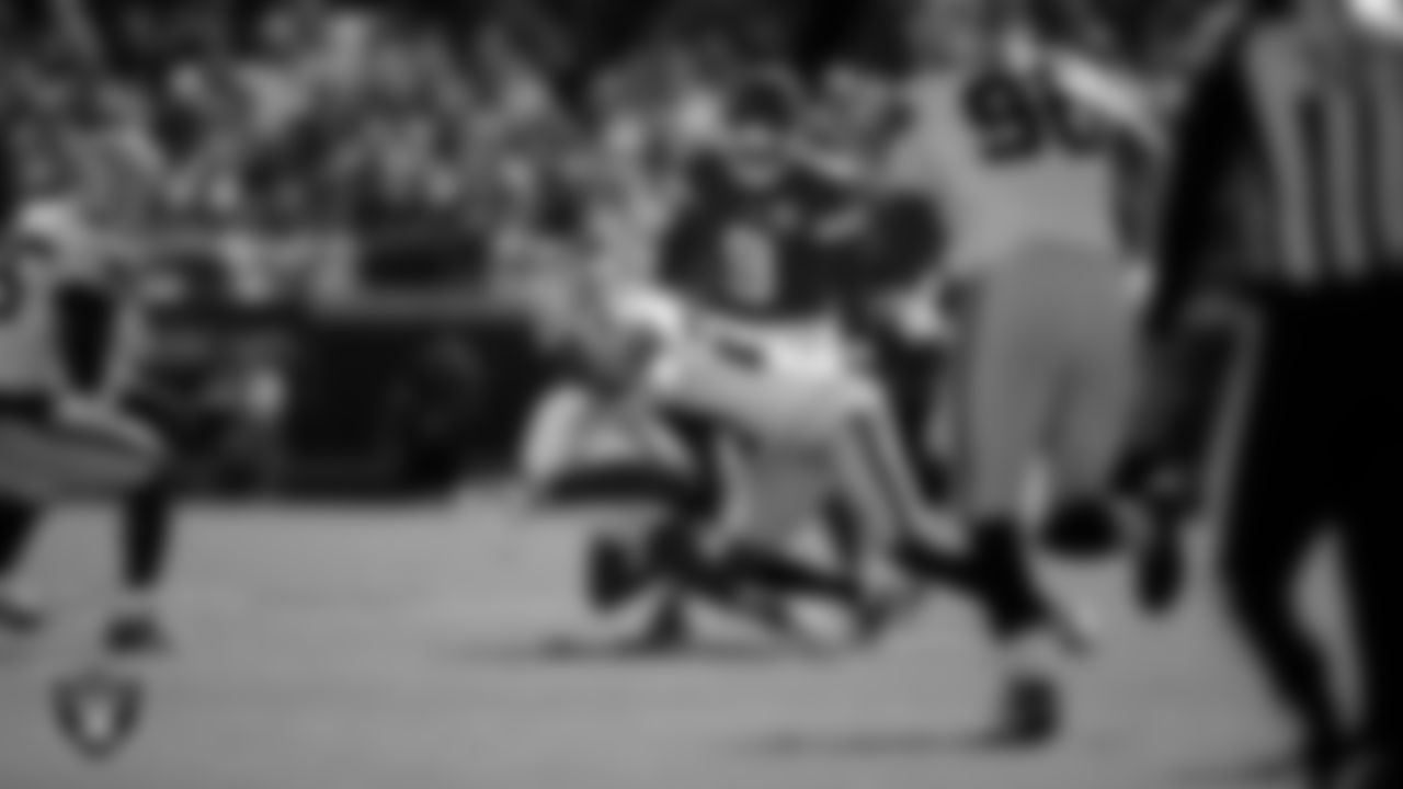 Las Vegas Raiders safety Isaiah Pola-Mao (20) makes a tackle during the regular season away game against the Kansas City Chiefs at GEHA Field at Arrowhead Stadium.