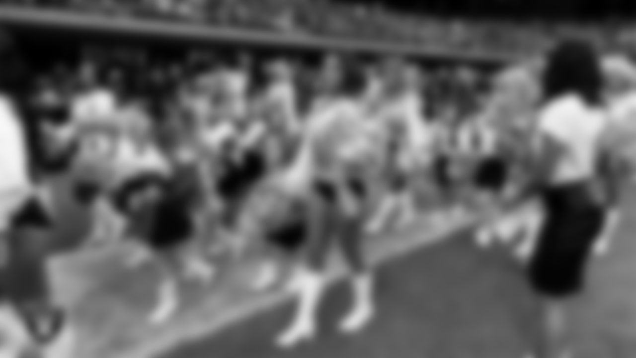 Raiderette Maddie and Junior Raiderettes exit the field after their performance before the preseason home game against the San Francisco 49ers at Allegiant Stadium.
