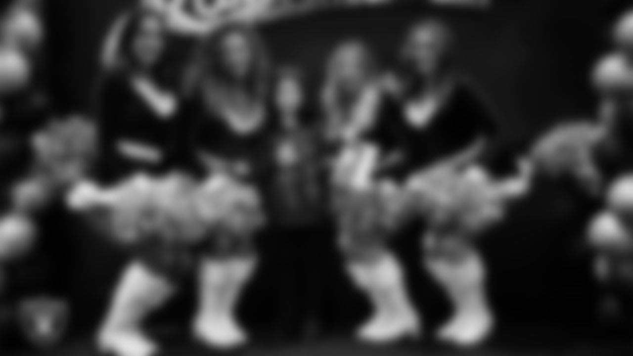 Raiderettes pose for a photo with a Junior Raiderette during the Junior Raiderettes Banquet at The Studio.