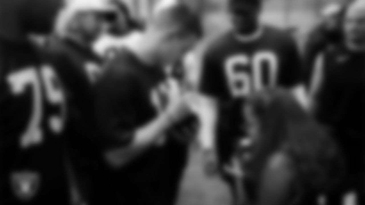 Las Vegas Raiders wide receiver Jack Bech (18) signs an autograph for Intermountain Children's Health patient Luna at Intermountain Health Performance Center.