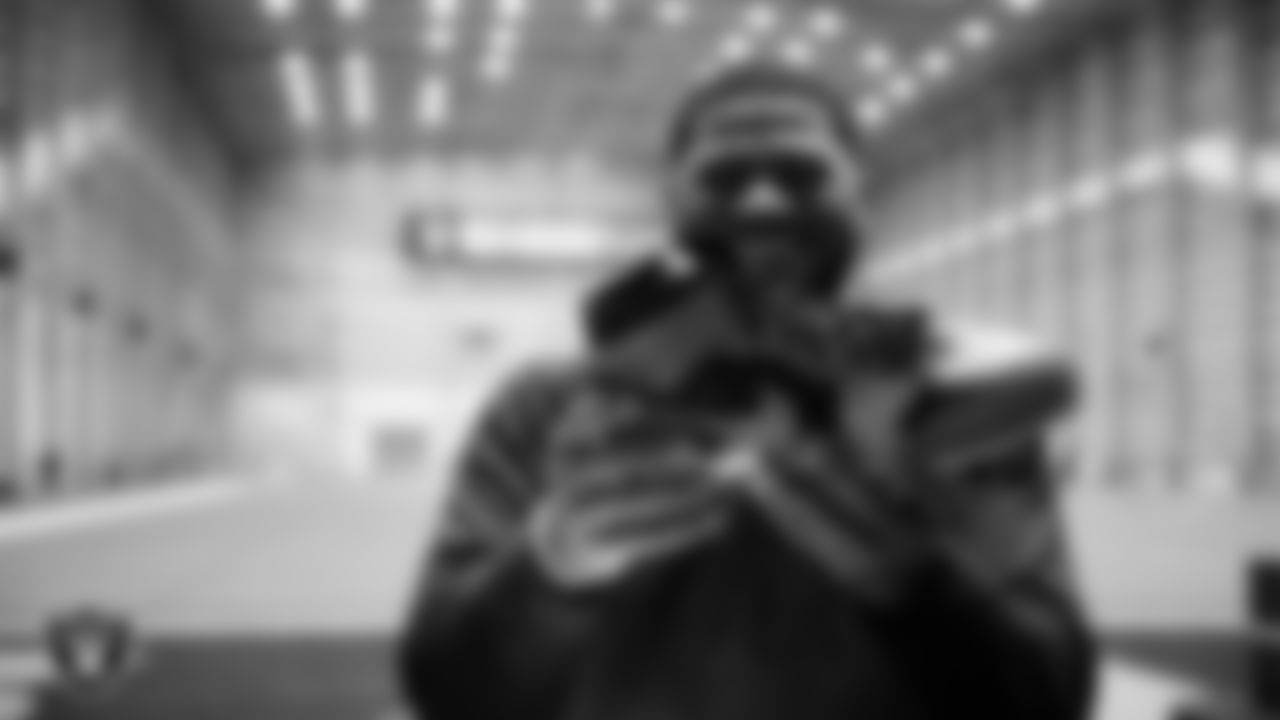 Las Vegas Raiders defensive tackle Jonah Laulu (96) unboxes his custom cleats for the NFL's My Cause My Cleats initiative at Intermountain Health Performance Center.