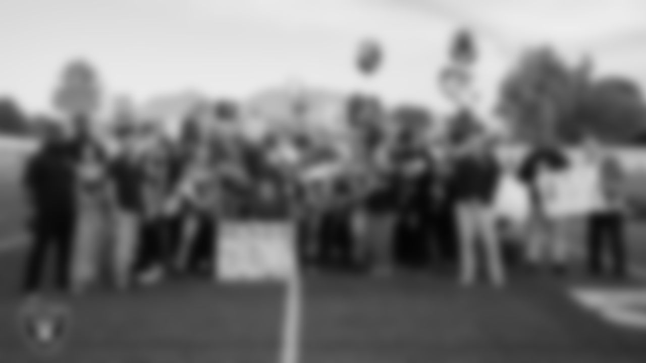 Mater East Academy flag football players and their families pose for a photo in celebration of Senior Night at Mater East Academy.