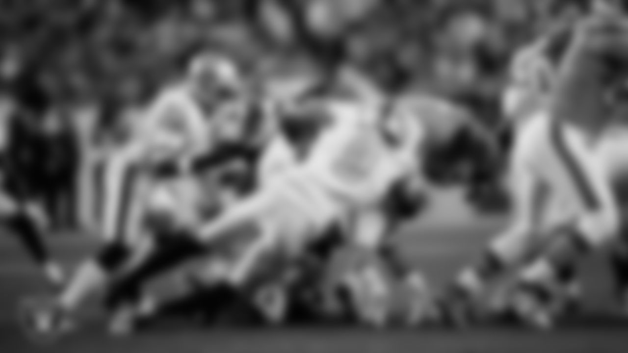 Las Vegas Raiders defensive end Tyree Wilson (9) makes a tackle during the regular season away game against the Denver Broncos at Empower Field at Mile High.