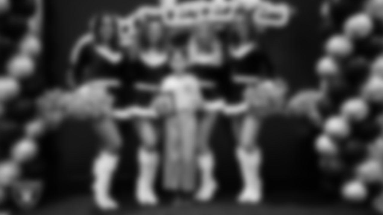 Raiderettes pose for a photo with a Junior Raiderette during the Junior Raiderettes Banquet at The Studio.