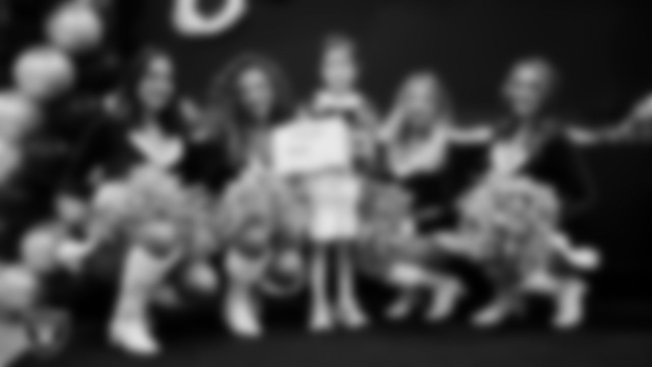 Raiderettes pose for a photo with a Junior Raiderette during the Junior Raiderettes Banquet at The Studio.