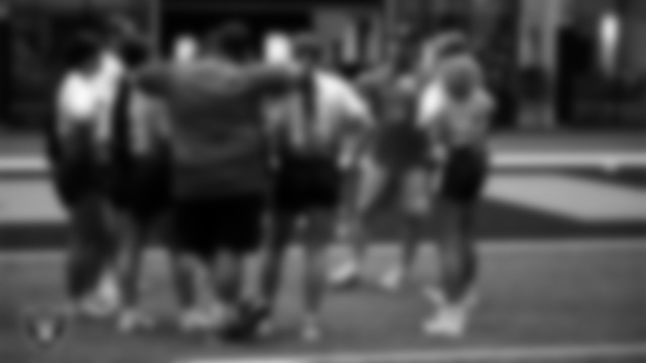 Athletes and coaches huddle during practice at Intermountain Health Performance Center.