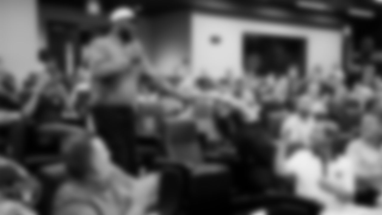 Las Vegas Raiders TV host Baron Davis fist bumps an attendee during the State of the Team at Intermountain Health Performance Center.