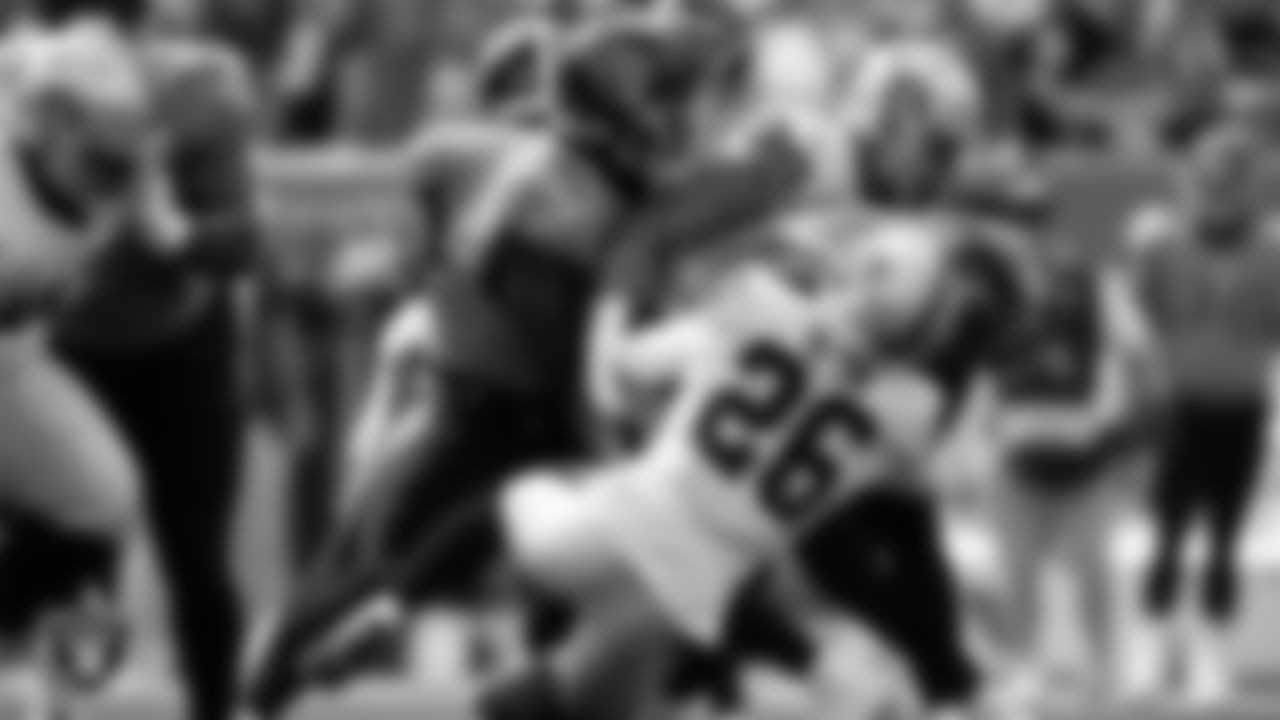 Las Vegas defensive end Maxx Crosby (98) and cornerback Rock Ya-Sin (26) make a tackle during the regular season away game against the Tennessee Titans at Nissan Stadium, Sunday, September 25, 2022, in Nashville, Tenn.