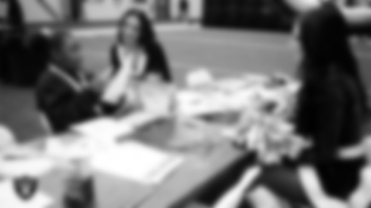 Raiderettes Kylie and Kylee and a student enjoy an activity during a Raiders Youth Holiday Party at Intermountain Health Performance Center.