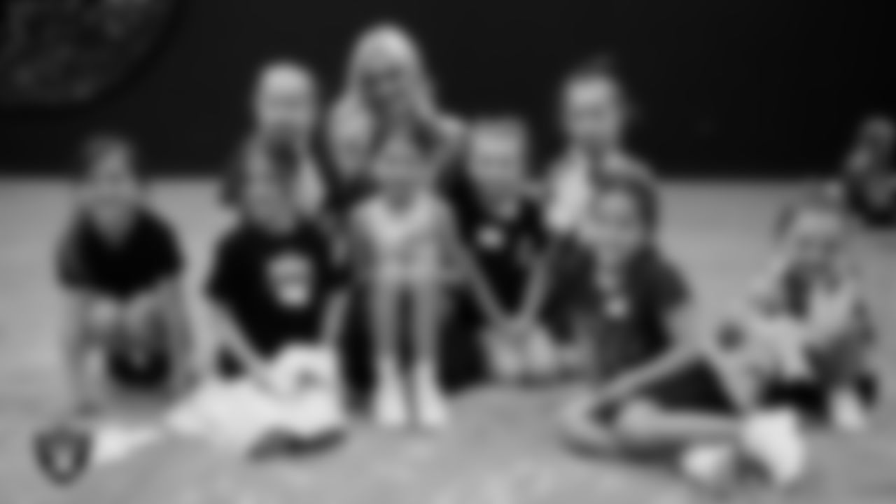 Raiderette Kennedy poses for a photo with dancers during day two of summer camp at The Studio.