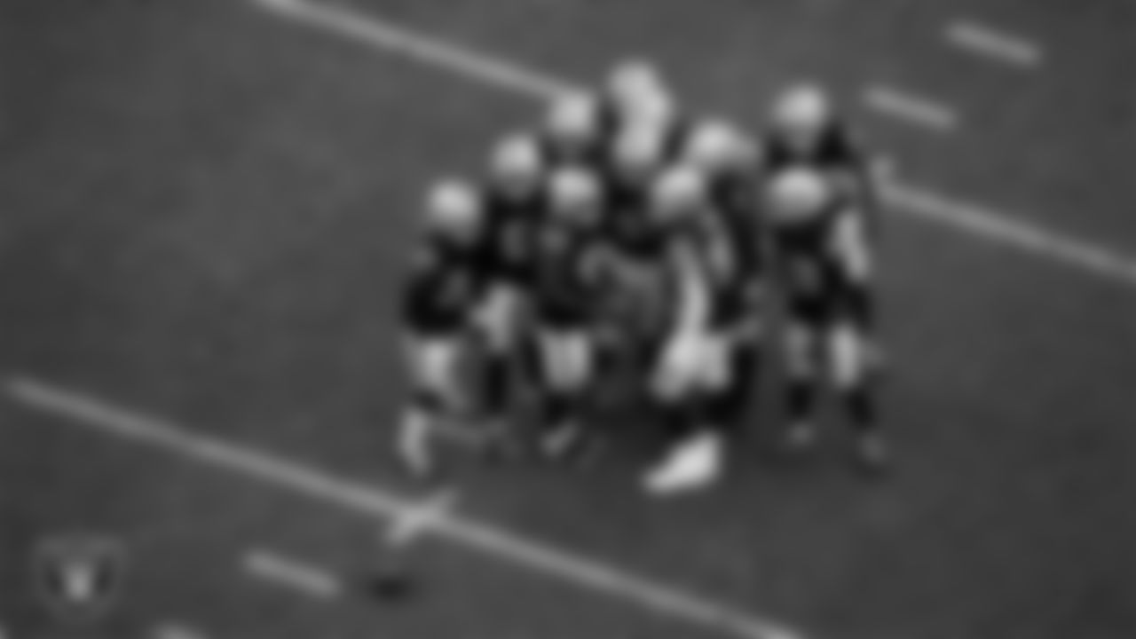 The Las Vegas Raiders defense huddles during the regular season home game against the Tennessee Titans at Allegiant Stadium.