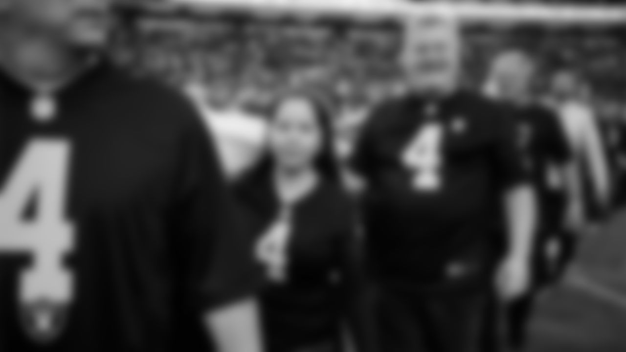 The American flag is displayed by Personal Seat License (PSL) holders on the field during the national anthem before the Las Vegas Raiders' regular season home game against the Cleveland Browns at Allegiant Stadium.