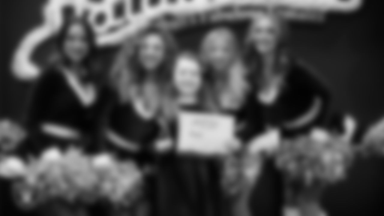 Raiderettes pose for a photo with a Junior Raiderette during the Junior Raiderettes Banquet at The Studio.