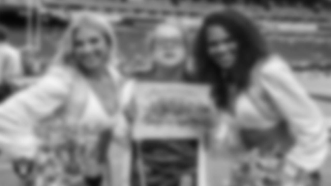 Raiderettes Cori and Shayla with Intermountain Children's Health patient Luna before the Las Vegas Raiders' regular season home game against the Tennessee Titans at Allegiant Stadium.