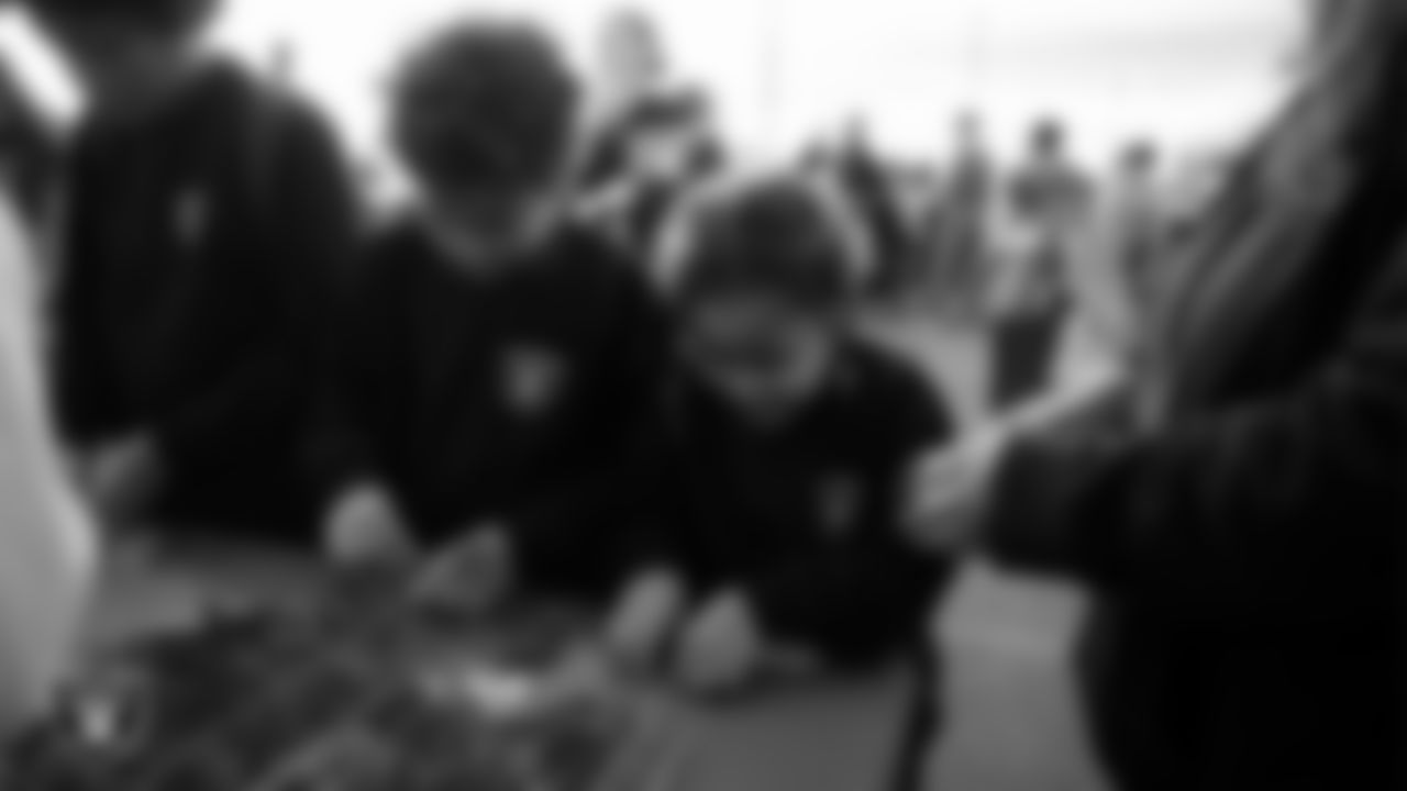 Children decorate ornaments during the Raiders Holiday Salute at Nellis Air Force Base - Coral Academy.