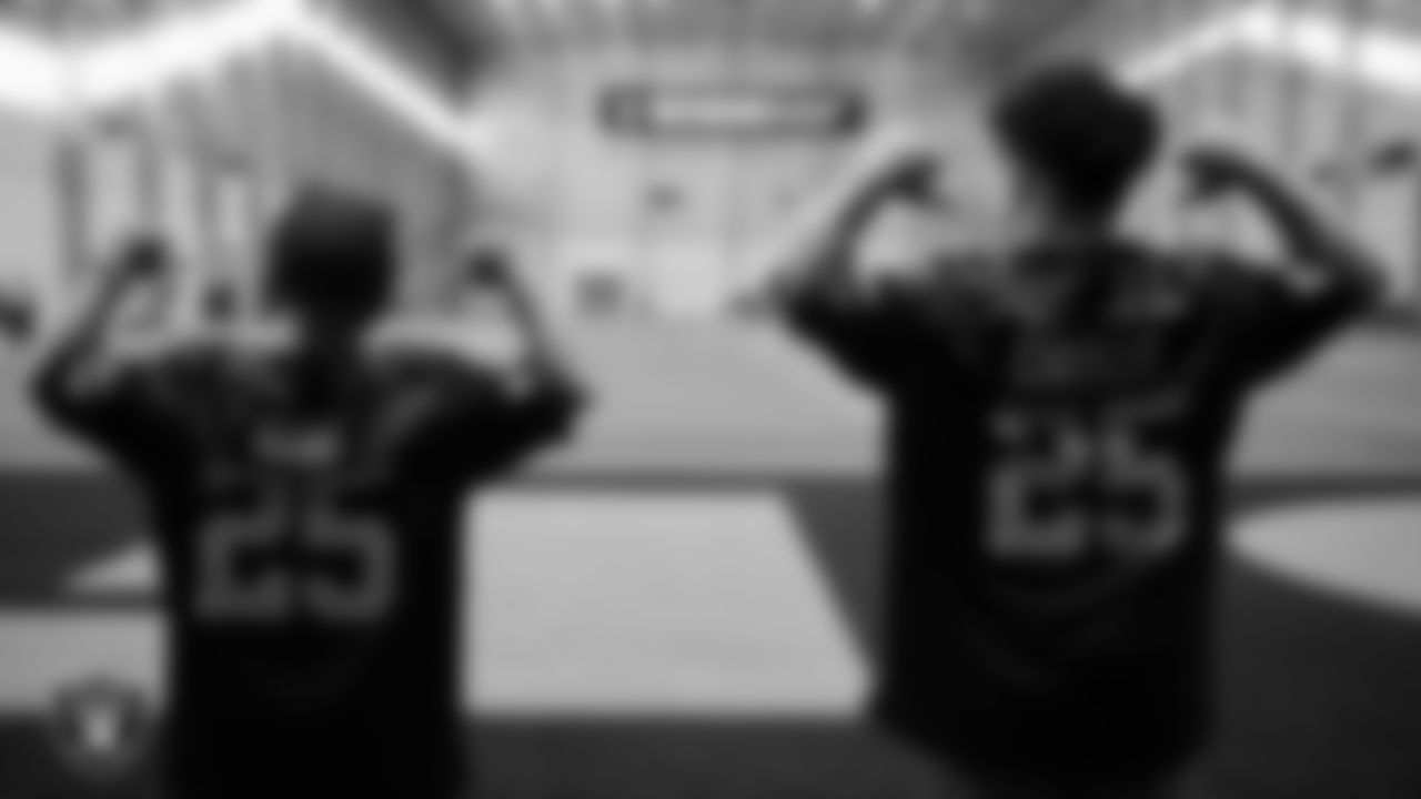 Christopher Arias and Marcos Carrillo from Make-A-Wish show off their signed jerseys during a visit to Intermountain Health Performance Center.