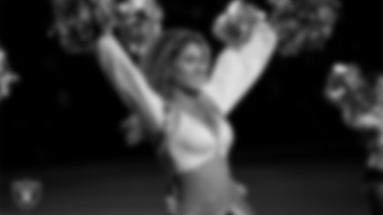 Raiderette Jenna walks onto the field for a performance during the regular season home game against the Dallas Cowboys at Allegiant Stadium.