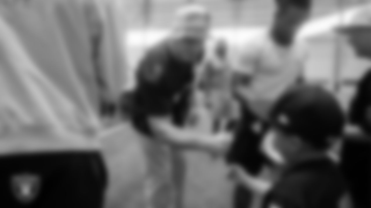 Cruz Avila from the Make-A-Wish Foundation meets Las Vegas Raiders linebacker Robert Spillane (41) during a visit to Intermountain Health Performance Center.